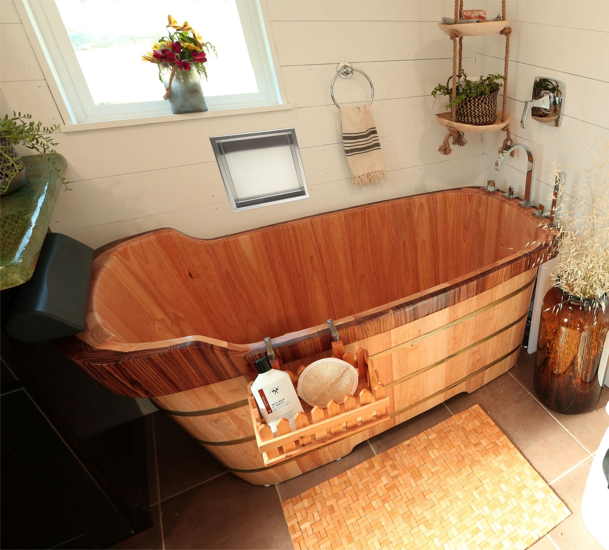 ALFI Brand Wooden bathtub in a bathroom with decorative elements. - Luxe Tub Source