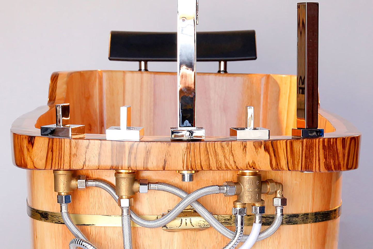 ALFI Brand close up of the rear of Wooden bathtub with metal fixtures.  - Luxe Tub Source