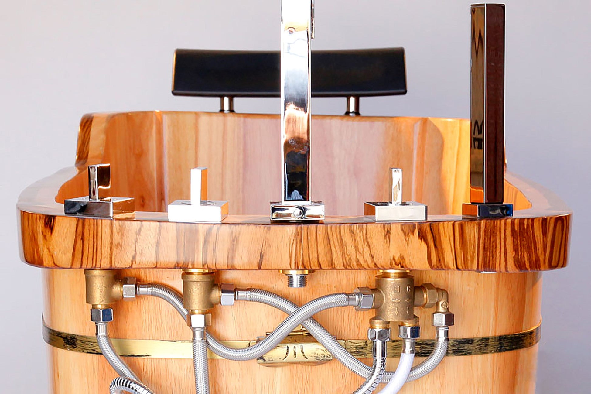 ALFI Brand close up of the rear of Wooden bathtub with metal fixtures.  - Luxe Tub Source