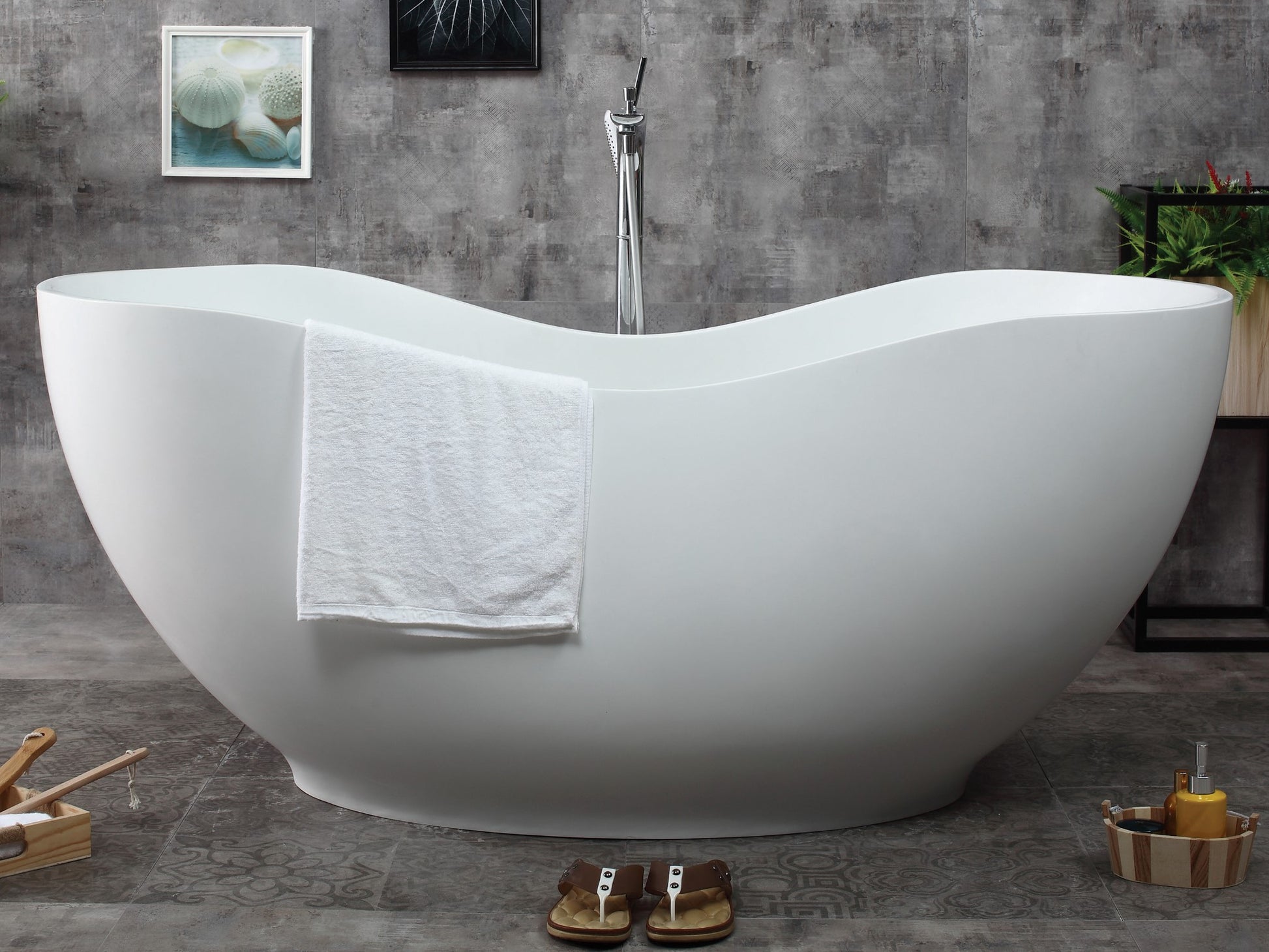 ALFI Brand White freestanding bathtub with a towel draped over it in a bathroom setting. - Luxe Tub Source