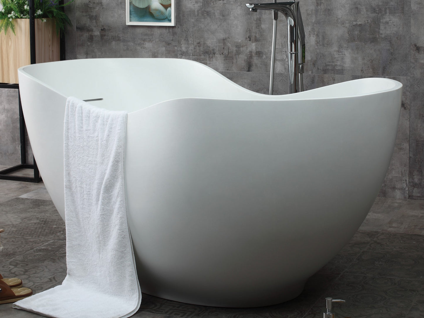 ALFI Brand front view of a White freestanding bathtub in a bathroom setting with a towel draped over it. - Luxe Tub Source 