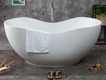 ALFI Brand White freestanding bathtub in a bathroom with a towel draped over it and sandles on the floor. - Luxe Tub Source