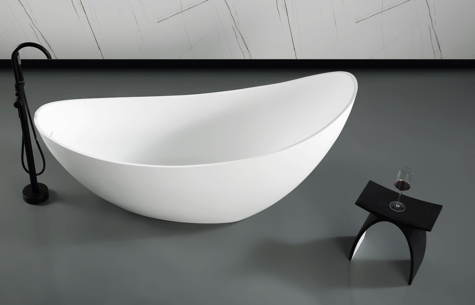 ALFI Brand side view of Modern white freestanding bathtub in a bathroom setting with a glass of wine on a stool. - Luxe Tub Source