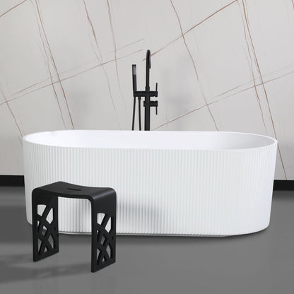 ALFI Brand White freestanding bathtub with a black stool and shower head against a tiled wall. - Luxe Tub Source