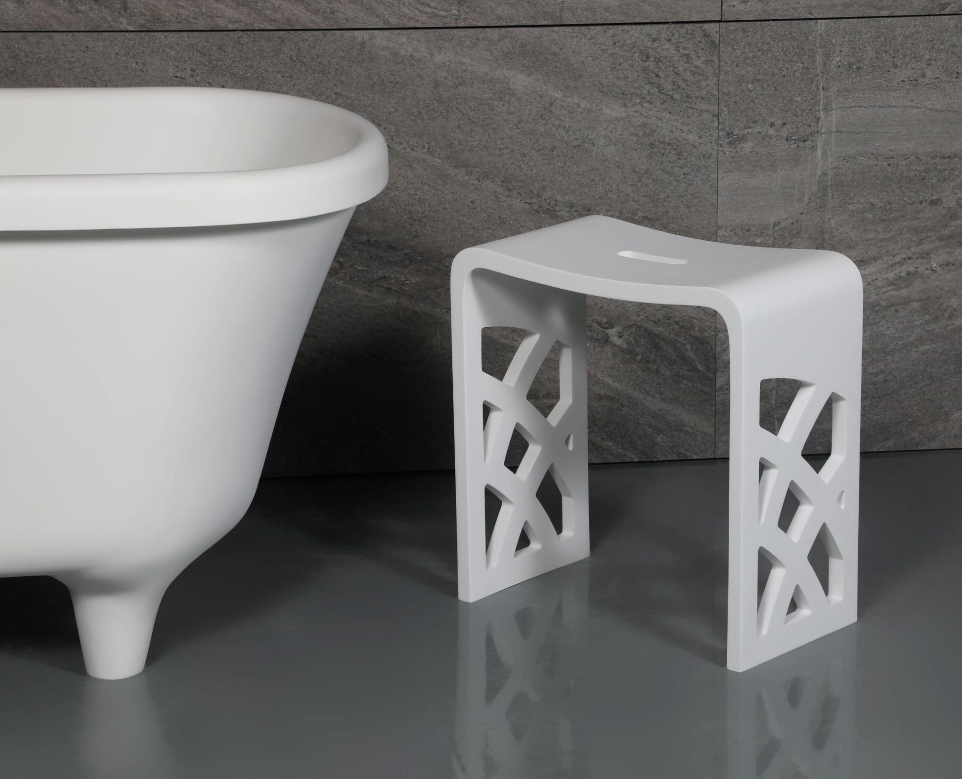 ALFI Brand White lattice-patterned stool next to a freestanding bathtub in a bathroom setting. - Luxe Tub Source