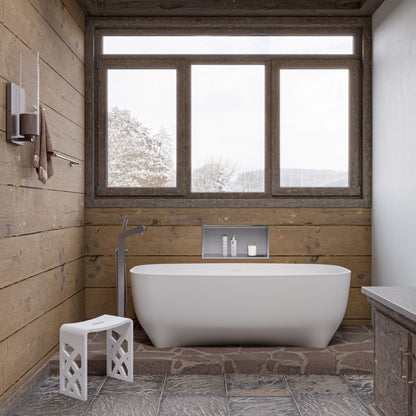 ALFI Brand Modern bathroom with a freestanding bathtub and white stool in a wooden cabin setting. - Luxe Tub Source