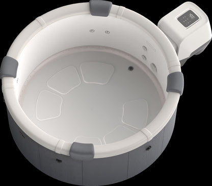 Top view of a hot tub with white interior and grey exterior.