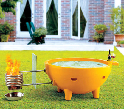 ALFI Brand Yellow Outdoor Wood-Burning Hot Tub with flames on a grassy lawn - Luxe Tub Source