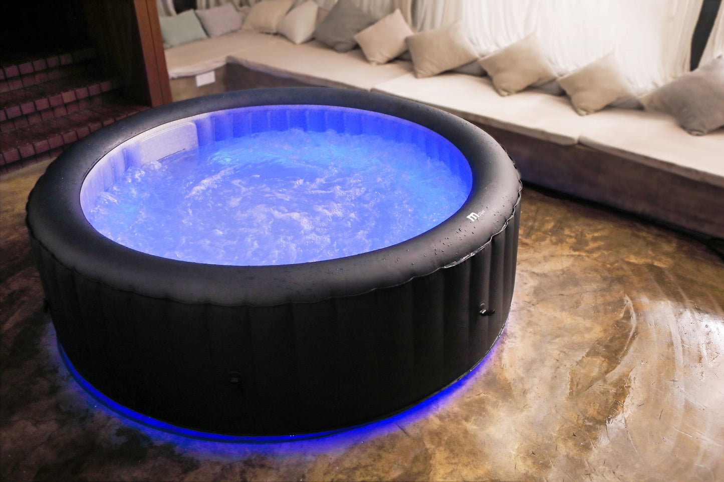 Inflatable hot tub with blue water in a living room setting