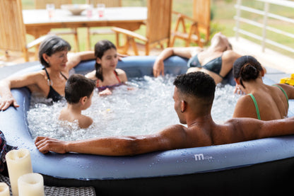 MSpa Group of people relaxing in an inflatable hot tub outdoors.  - Luxe Tub Source