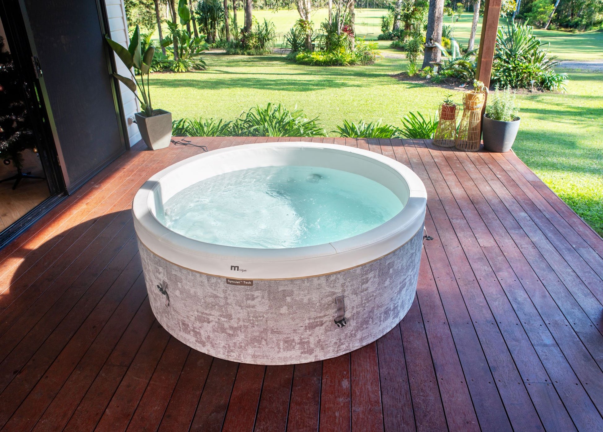 MSpa Hot tub on a wooden deck with a garden view. - Luxe Tub Source