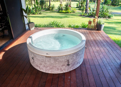 MSpa Hot tub on a wooden deck with a garden view. - Luxe Tub Source