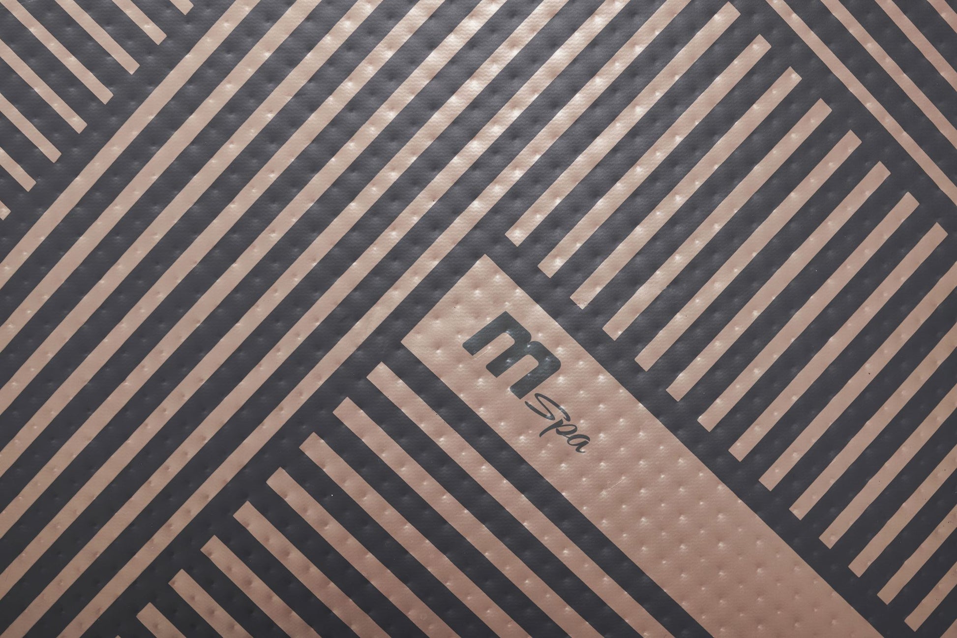 MSpa Close-up of a hot tub with diagonal lines and a Mspa logo. - Luxe Tub Source