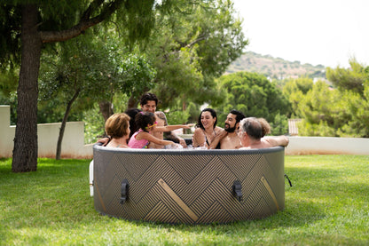 MSpa Family enjoying a hot tub outdoors in a park-like setting. - Luxe Tub Source