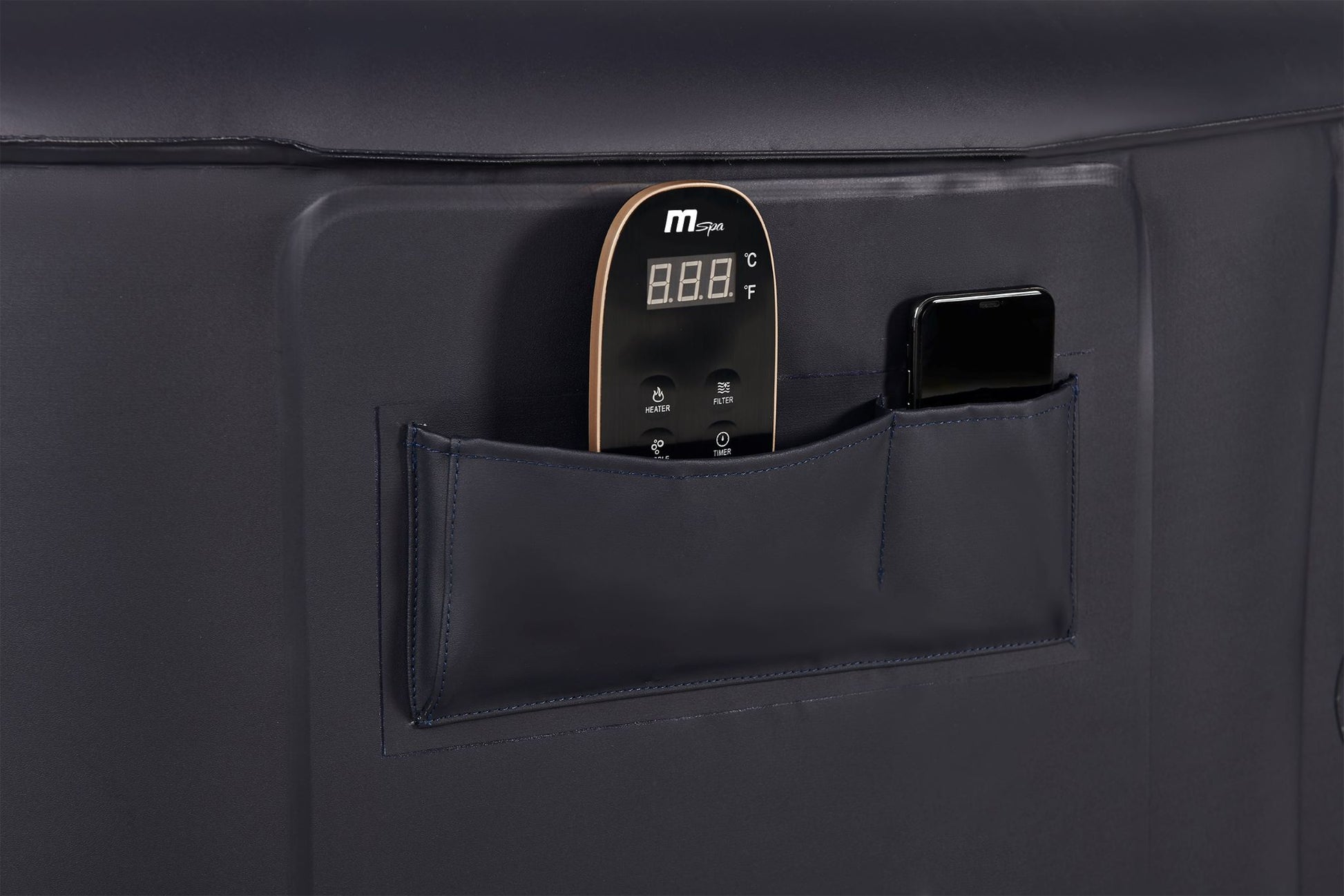 Hot tub remote control and a cell phone in the pockets of the Mspa Aurora hot tub.