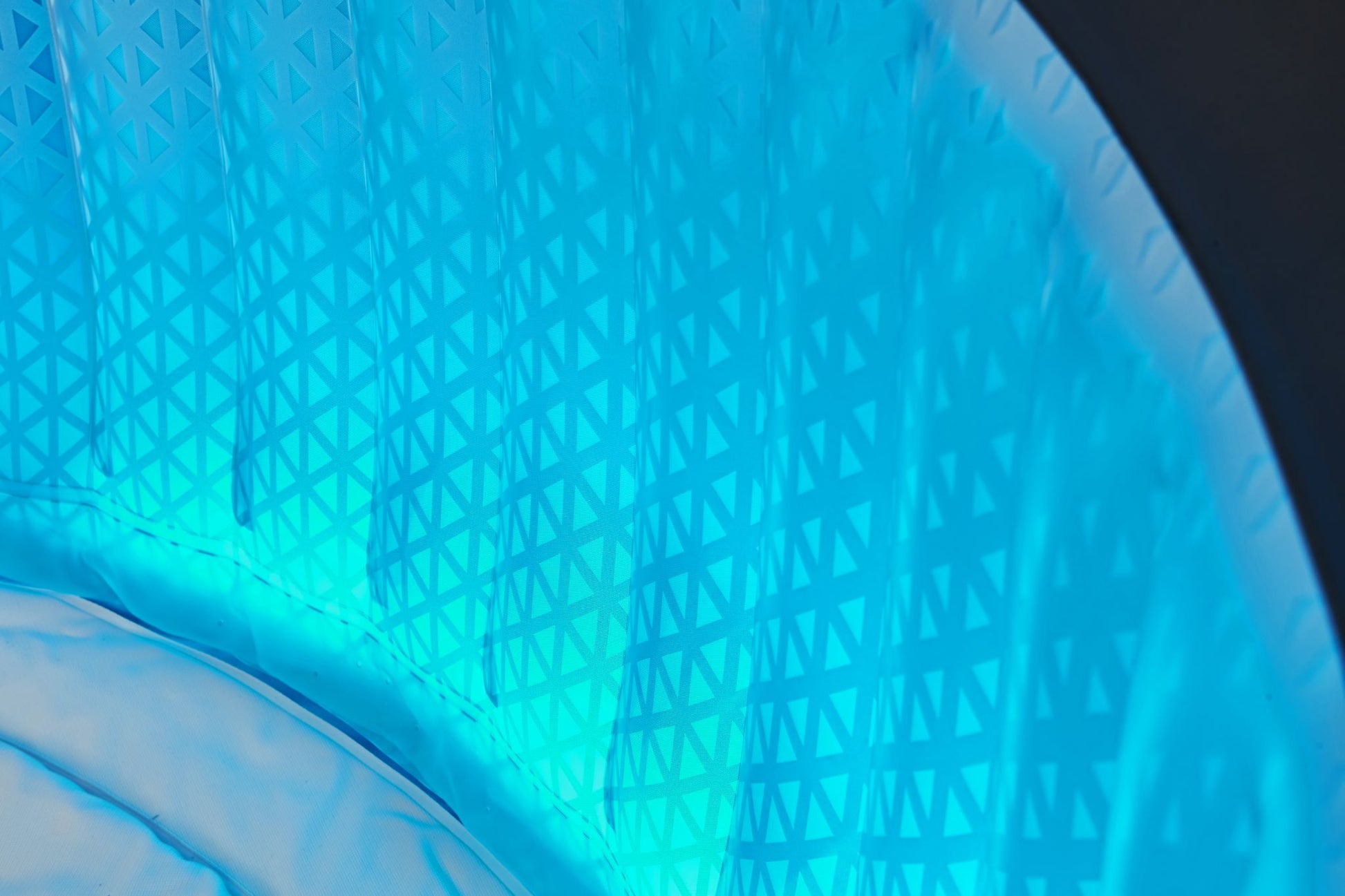 Close-up of the Mspa Aurora hot tub interior wall with blue LED lighting.